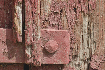 Metal element with peeling paint on the old door