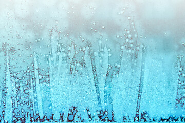Frosty patterns on glass. Beautiful winter background. Christmas and New Year.