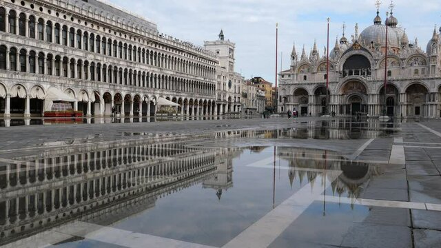 Venice, Italy - December 2020 - San Marco square, monuments reflected on the high water