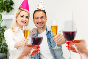 A happy family with a child is celebrating Christmas with their friends on video call using webcam. Family greeting their relatives on Christmas eve online. New normal virtual event