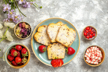 top view yummy cake slices with strawberries and candies on a light background cake pie sweet