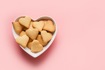 Homemade traditional heart shaped cookies for Valentine's day on pink background. Top view. Space for wishes. Greeting card.