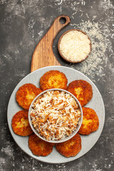 top view tasty fried cutlets with cooked rice on a dark desk meat rissole dish