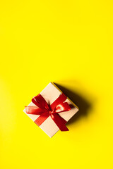 cardboard box gift yellow background, banner bow red ribbon