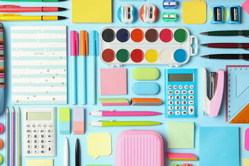 Flat lay composition with different school stationery on light blue background. Back to school