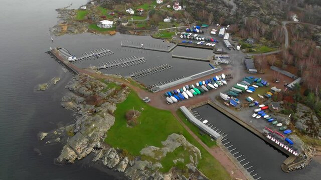 Aerial view of small harbor with empty docks and winterized boats ashore