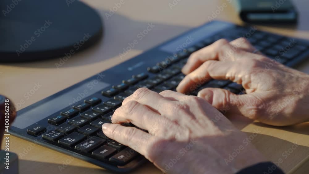 Poster close shot of the hands of a man typing on a computer keyboard.