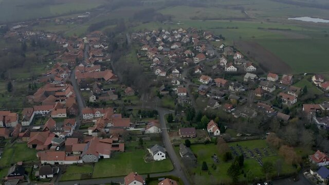 Drone aerial of the typical german village Seeburg located at the Seeburger See on a beautiful Sunday morning. A scenic winter and autumn landscape inviting for a hike with the family in Germany.