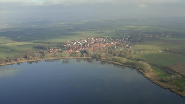 Drone Aerial shot of the Lake Seeburg in winter near Goettingen in lower saxony, Germany, Europe.
