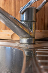 Rust and Calcium scale deposits on old stainless kitchen sink faucet macro close up shot