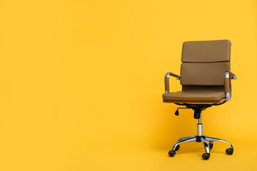Modern office chair on yellow background. Space for text