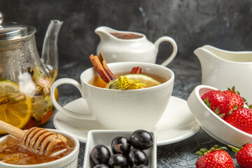 front view cup of tea with olives and honey on a dark background morning food breakfast