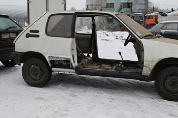 Photo of a broken disassembled car without a door