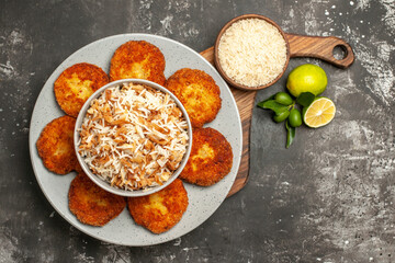 top view tasty fried cutlets with cooked rice on the dark background meat rissole dish