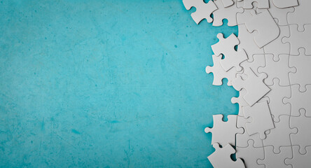 white puzzle pieces on a blue background