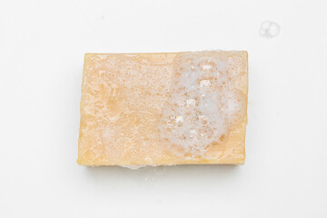 Soap bar and foam on white background, top view. Mockup for design