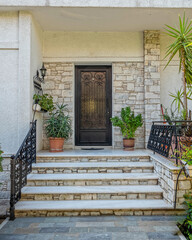 contemporary house entrance stairs to door and flowerpots, Athens Greece