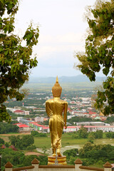 The 9 metres high golden Buddha image in walking posture of Wat Phra That Khao Noi, a hilltop...