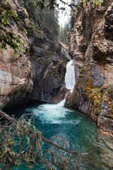Fototapeta na wymiar Lower falls flowing in Johnston Canyon at Banff national park