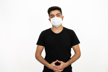 Young male model wearing a medical face mask. He is wearing a black shirt. White background and isolated image.