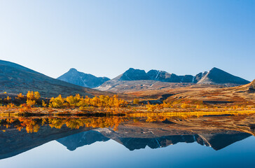 Mountains reflecting in lake at autumn, Norway