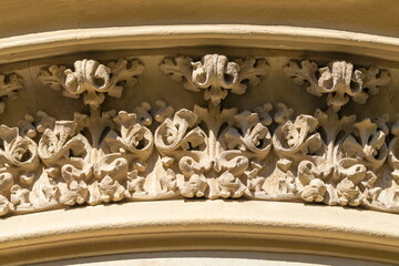 Elements of architectural decorations of buildings, gypsum stucco, plaster ornaments and patterns, wall texture. On the streets in Spain, public places. © Kozlik_mozlik