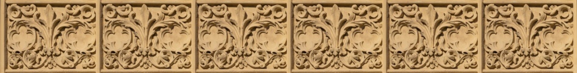 Elements of architectural decorations of buildings, gypsum stucco, plaster ornaments and patterns, wall texture. On the streets in Spain, public places. © Kozlik_mozlik