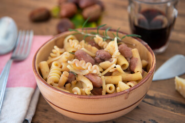 pasta and beans in a bowl on a wooden background, typical dish of Italian food