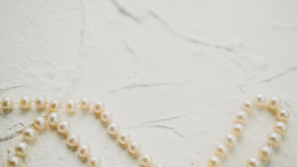 seashells pearls corals on a textured white background . space for text. the view from the top . notepad