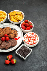 top view yummy choco biscuits with different snacks on a dark background sweet cookie tea