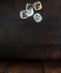 Side view of falling white dice. White casino dice on a dark background. Online casino dice...
