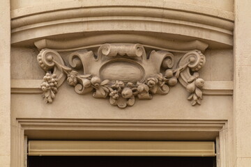 Elements of architectural decorations of buildings, gypsum stucco, plaster ornaments and patterns, wall texture. On the streets in Catalonia, public places. © Kozlik_mozlik