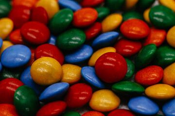 background of small round multicolored sweets close-up