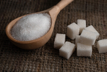 Pieces of lump sugar on burlap. granulated sugar close-up. Refined sugar. Sugar