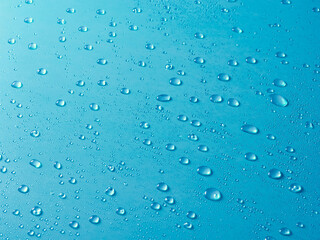Random water drops on the blue PVC surface