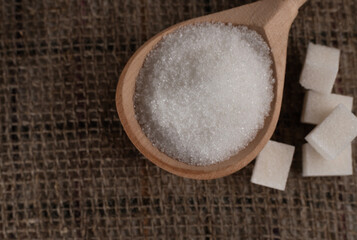 Pieces of lump sugar on burlap. granulated sugar close-up. Refined sugar. Sugar