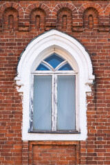 Framed white arch window old red brick building