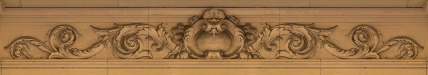 Elements of architectural decorations of buildings, gypsum stucco, plaster ornaments and patterns, wall texture. On the streets in Catalonia, public places. © Kozlik_mozlik
