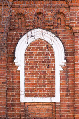 Walled old red brick arch framed white window front view