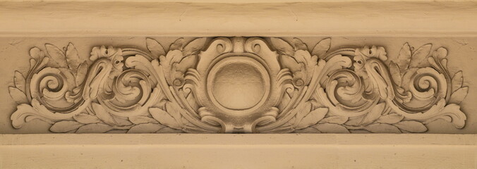 Elements of architectural decorations of buildings, gypsum stucco, plaster ornaments and patterns, wall texture. On the streets in Catalonia, public places. © Kozlik_mozlik