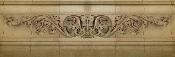 Elements of architectural decorations of buildings, gypsum stucco, plaster ornaments and patterns, wall texture. On the streets in Catalonia, public places. © Kozlik_mozlik