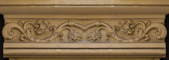 Elements of architectural decorations of buildings, gypsum stucco, plaster ornaments and patterns, wall texture. On the streets in Catalonia, public places. © Kozlik_mozlik