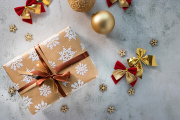 Christmas and New Year concept. A gift in a beautiful package on a gray background. Soft focus. Top view.
