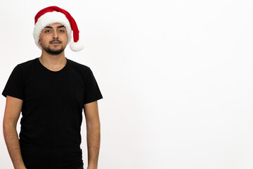 Young man wearing a Santa hat. He is wearing a black shirt. Isolated image white background.