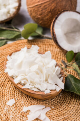 Whole and broken coconut with grated coconut flakes or chips.