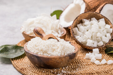 Whole and broken coconut with grated coconut flakes, chips, cubes.