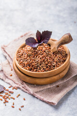 Brown Unpolished rice in wooden bowl. Long grain rice background.