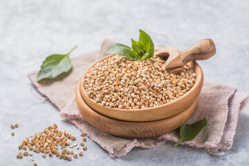 Green buckwheat groats on white background.