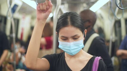 An young woman is wearing protective mask in metro , covid-19 protection , safety travel , new normal , social distancing , safety transportation , travel under pandemic concept .