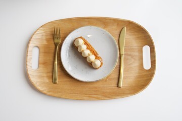 Eclair with meringues on a plate. European desserts on the New Year's table.